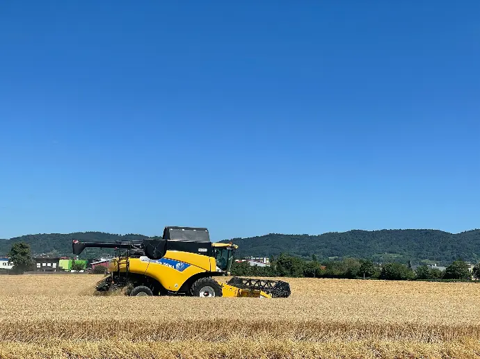 a yellow tractor in a field